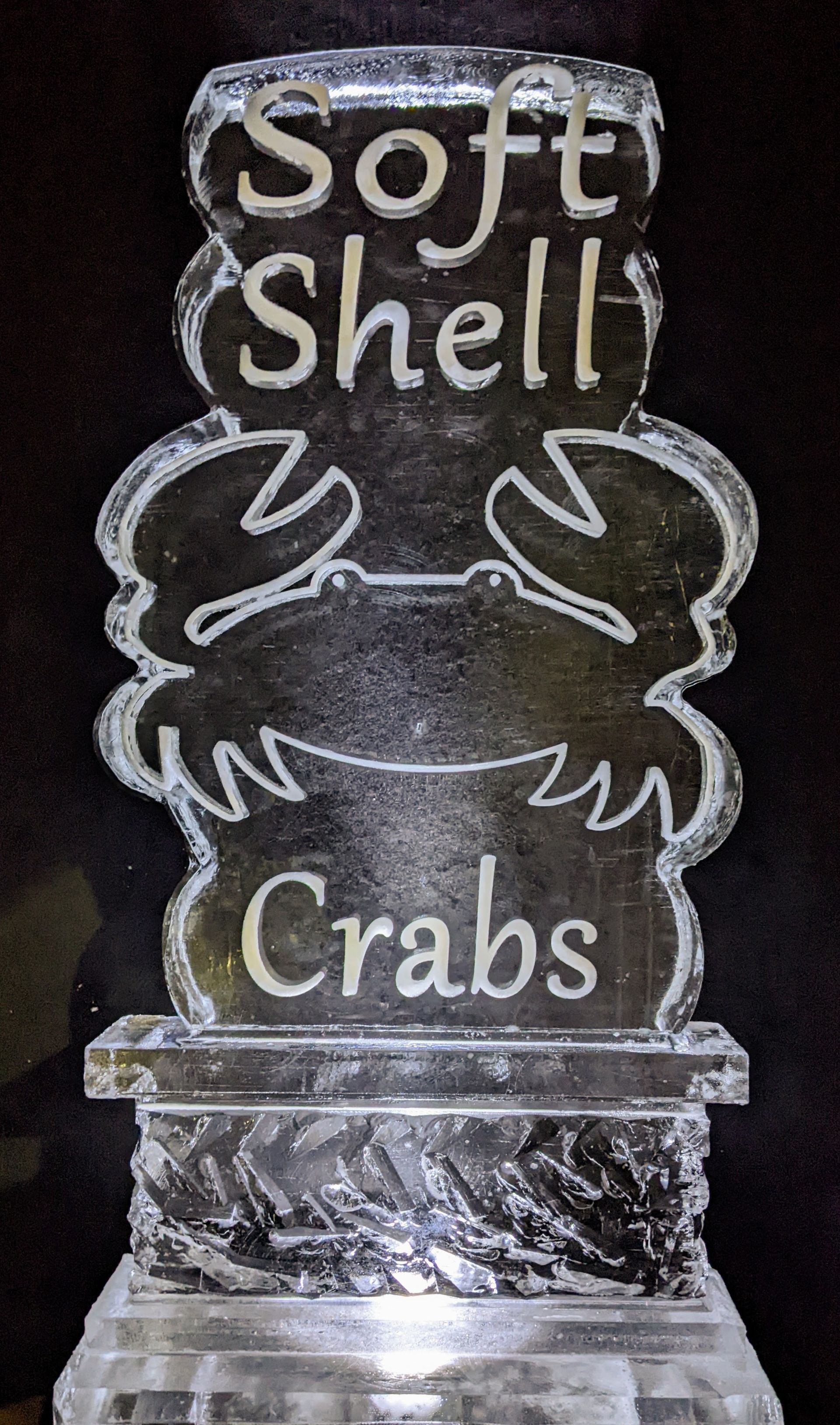 An ice sculpture that says soft shell crabs on it