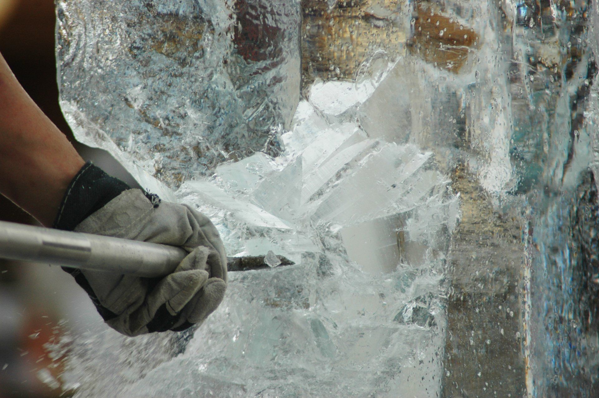 A person is carving an ice sculpture with a hammer.