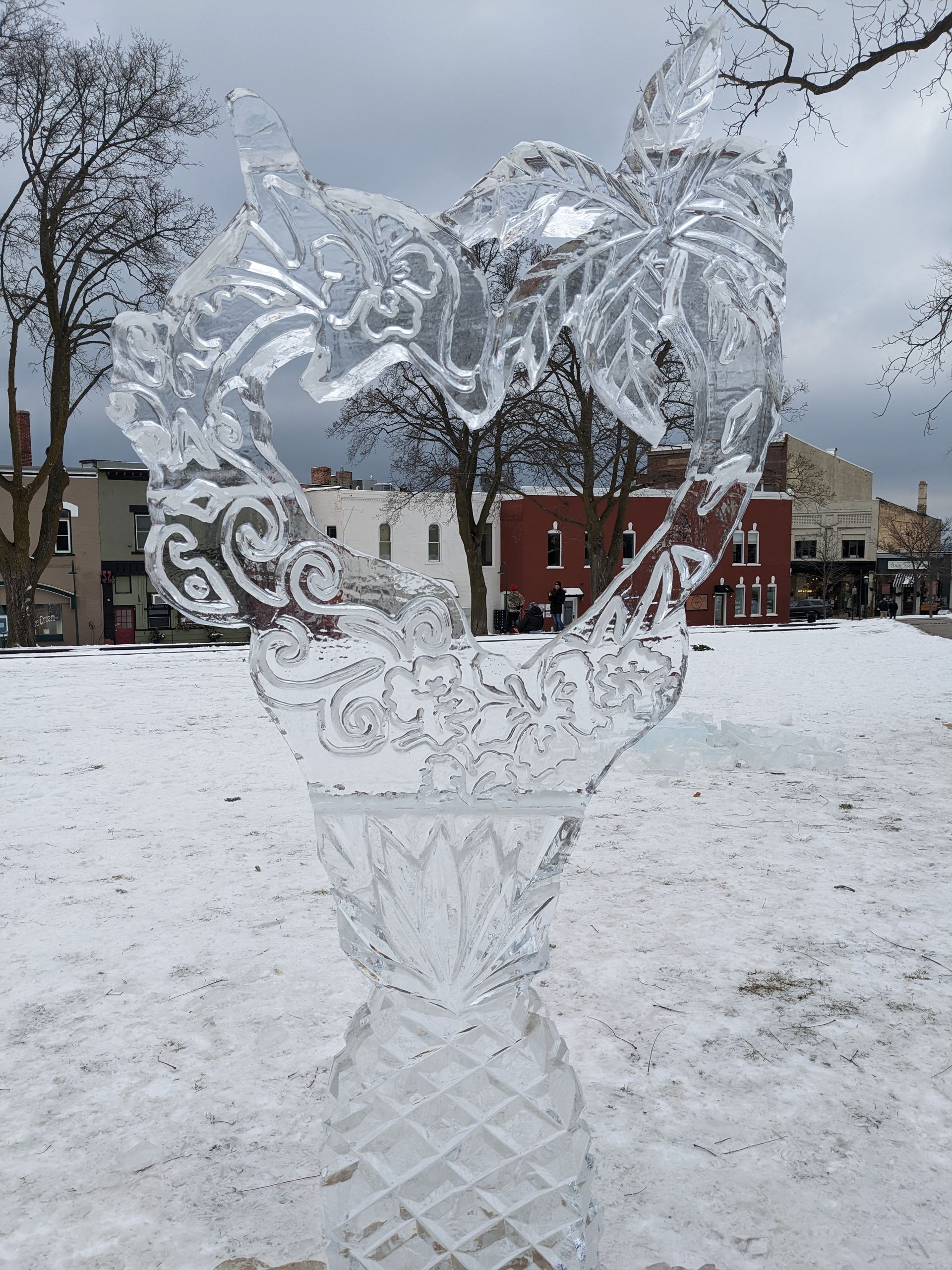 A heart shaped ice sculpture in a snowy park