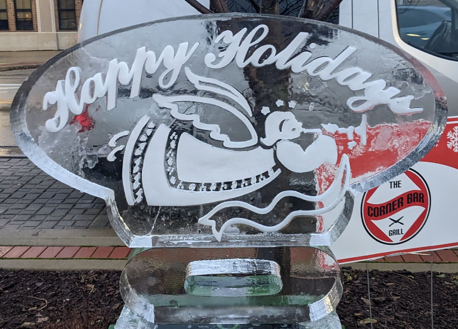 A large ice sculpture with the words `` happy holidays '' written on it