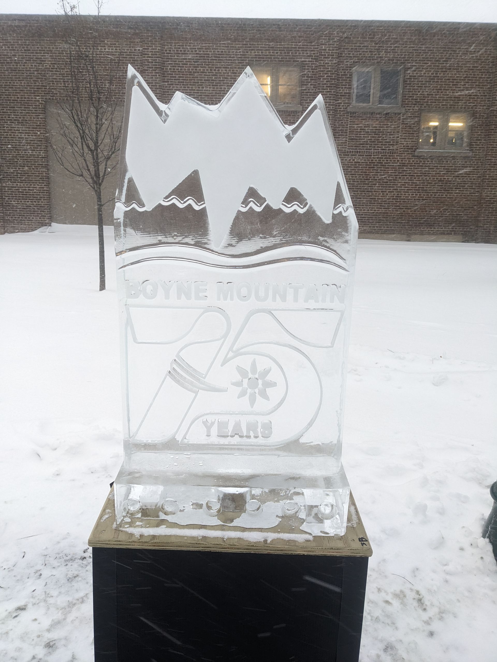 A large ice sculpture in front of a brick building