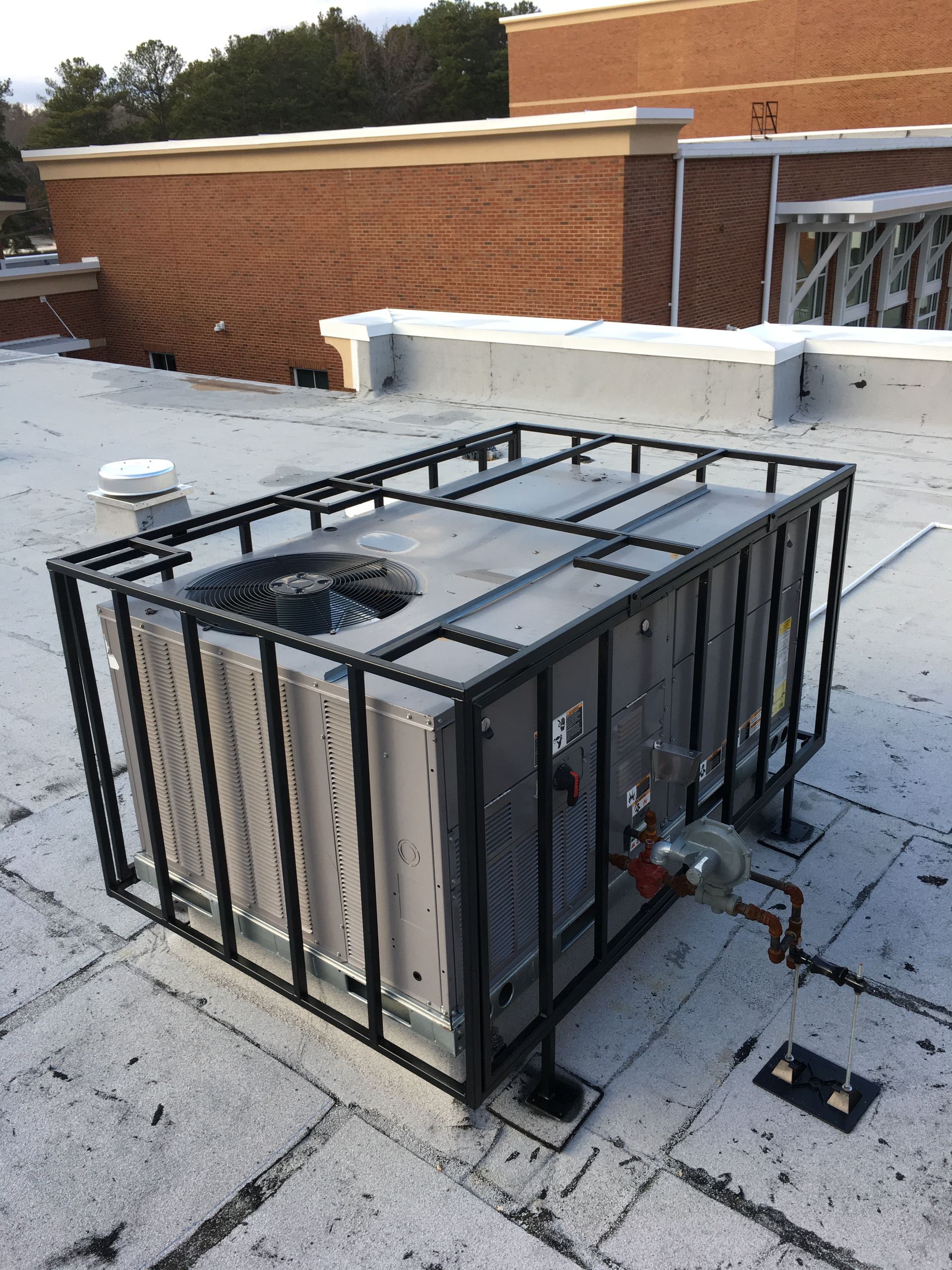An air conditioner is sitting on the roof of a building