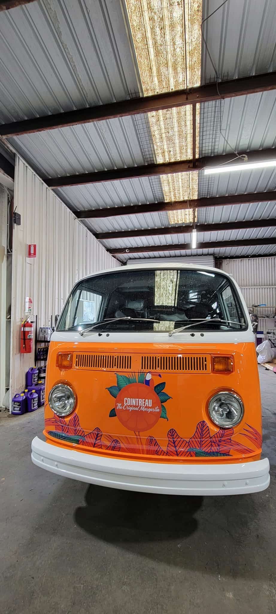 An Orange And White Van Is Parked In A Warehouse— Sojos Mechanical & Tyre Service In West Gosford, NSW