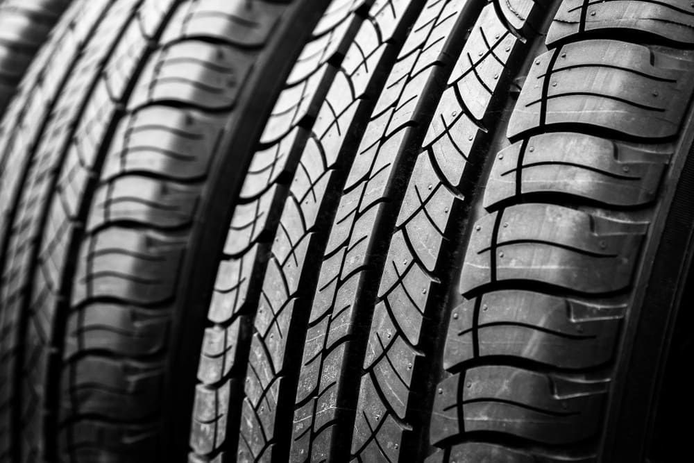 A Black And White Photo Of A Stack Of Tires — Sojos Mechanical & Tyre Service In West Gosford, NSW