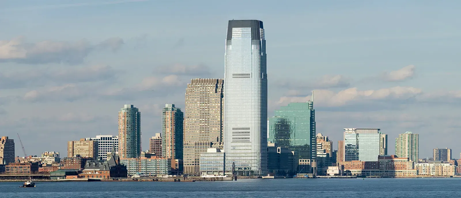 Stacks of folded towels and cloths in various colors: teal, orange, blue and white.