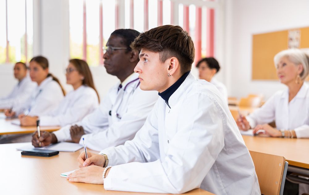 Students in White Lab Coats Taking Notes in a Classroom — Blue Stone Medical & Professional in West Rockhampton, QLD