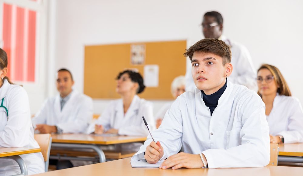 Students in White Lab Coats Taking Notes in a Classroom — Blue Stone Medical & Professional in West Rockhampton, QLD