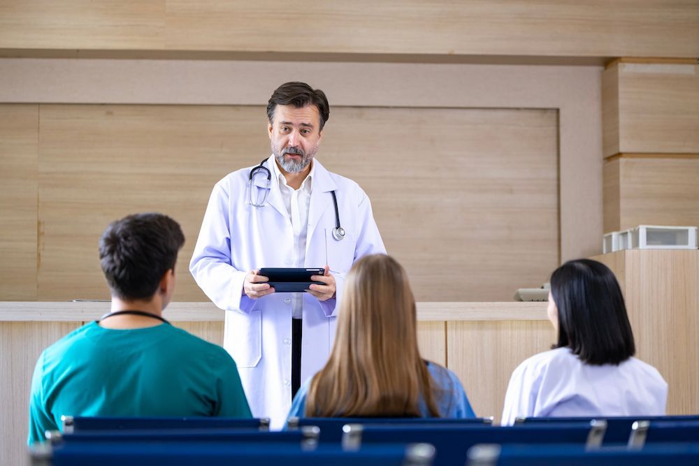 Doctor Speaking to Seated Students in a Classroom — Blue Stone Medical & Professional in West Rockhampton, QLD
