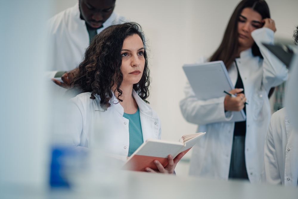 Doctor in White Coat Holding a Notebook in a Clinical Meeting — Blue Stone Medical & Professional in West Rockhampton, QLD