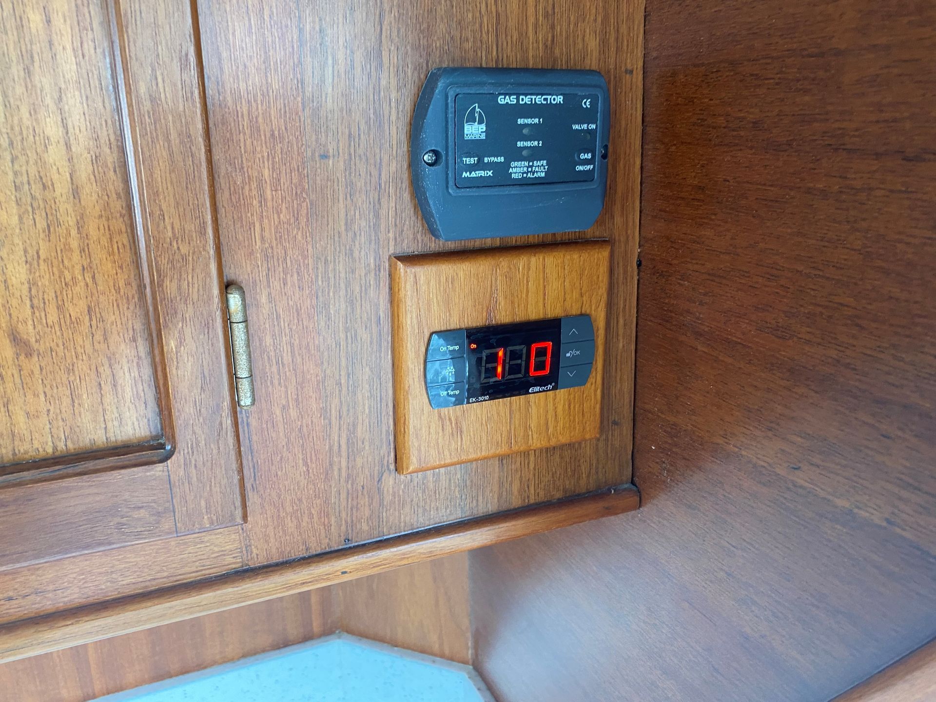 A kitchen with a stove top oven and a kettle