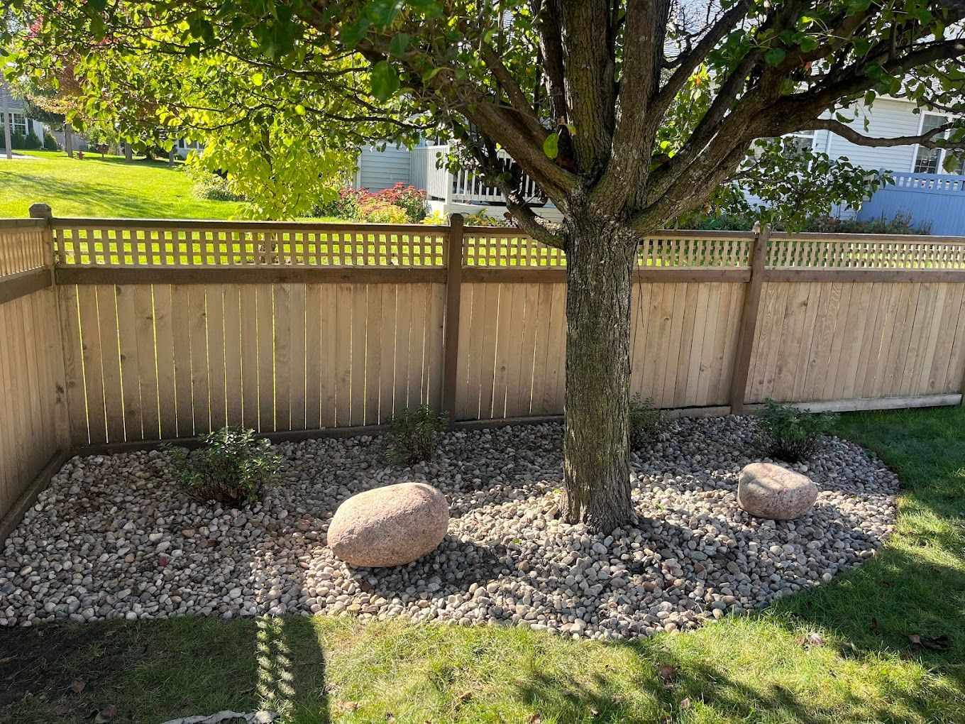 A wooden fence with a tree in the middle of it