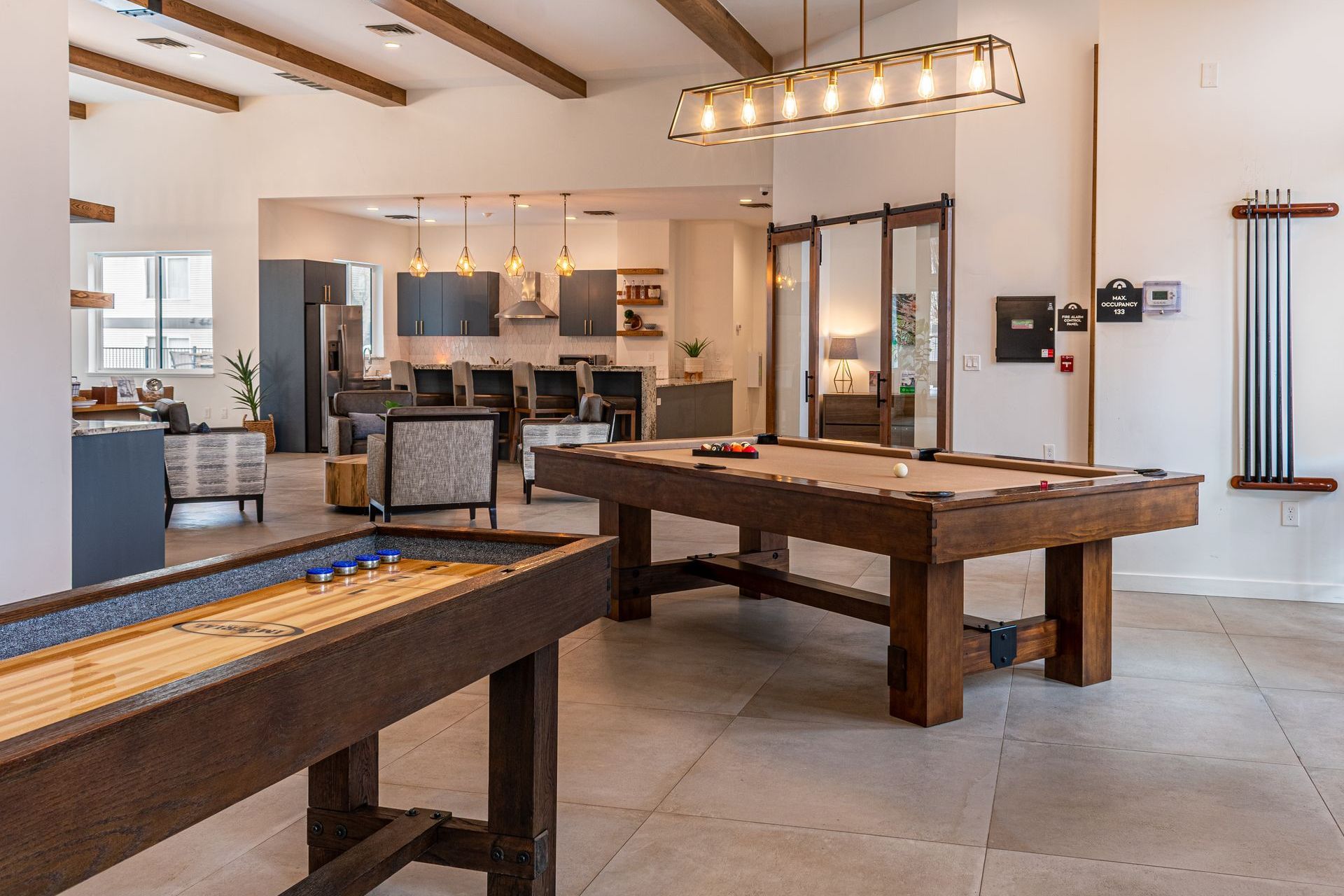 There is a pool table and a shuffleboard table in the room.
