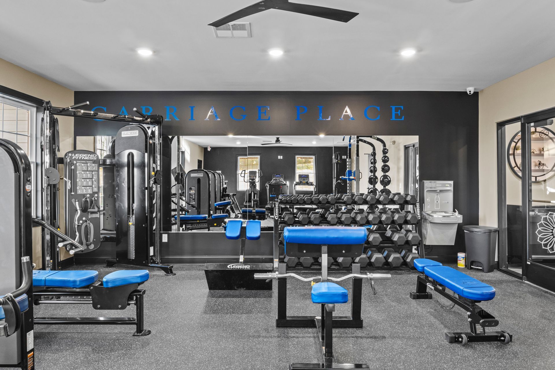 A woman is smiling while using a machine in a gym.