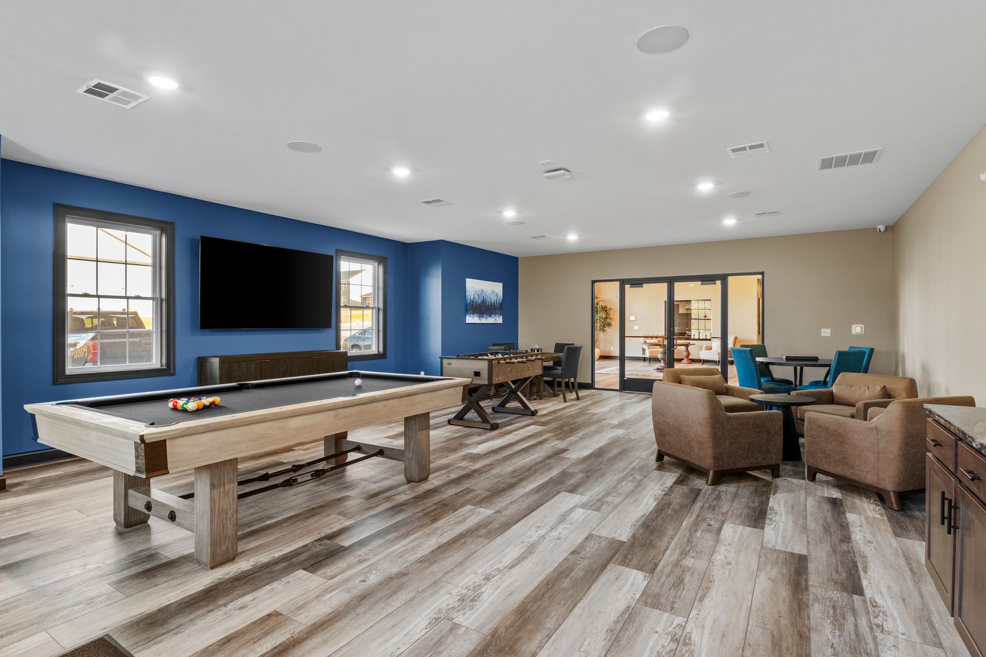 There is a pool table and a shuffleboard table in the room.