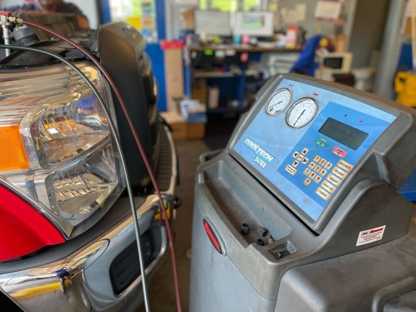 134A refrigerant machine connected to a truck for a recharge service