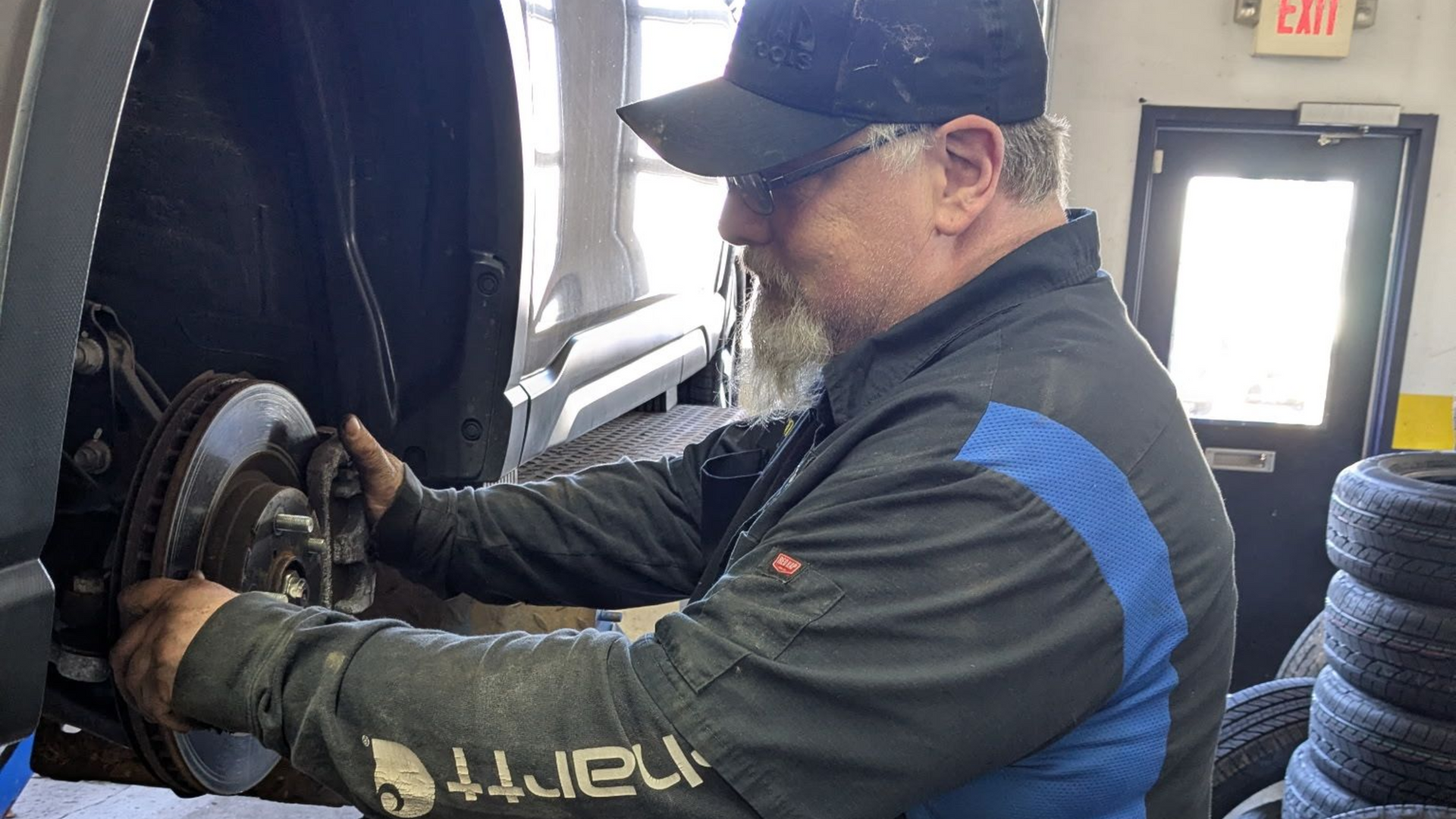 Mechanic inspecting brakes and suspension during service at Jamie's Tire & Service