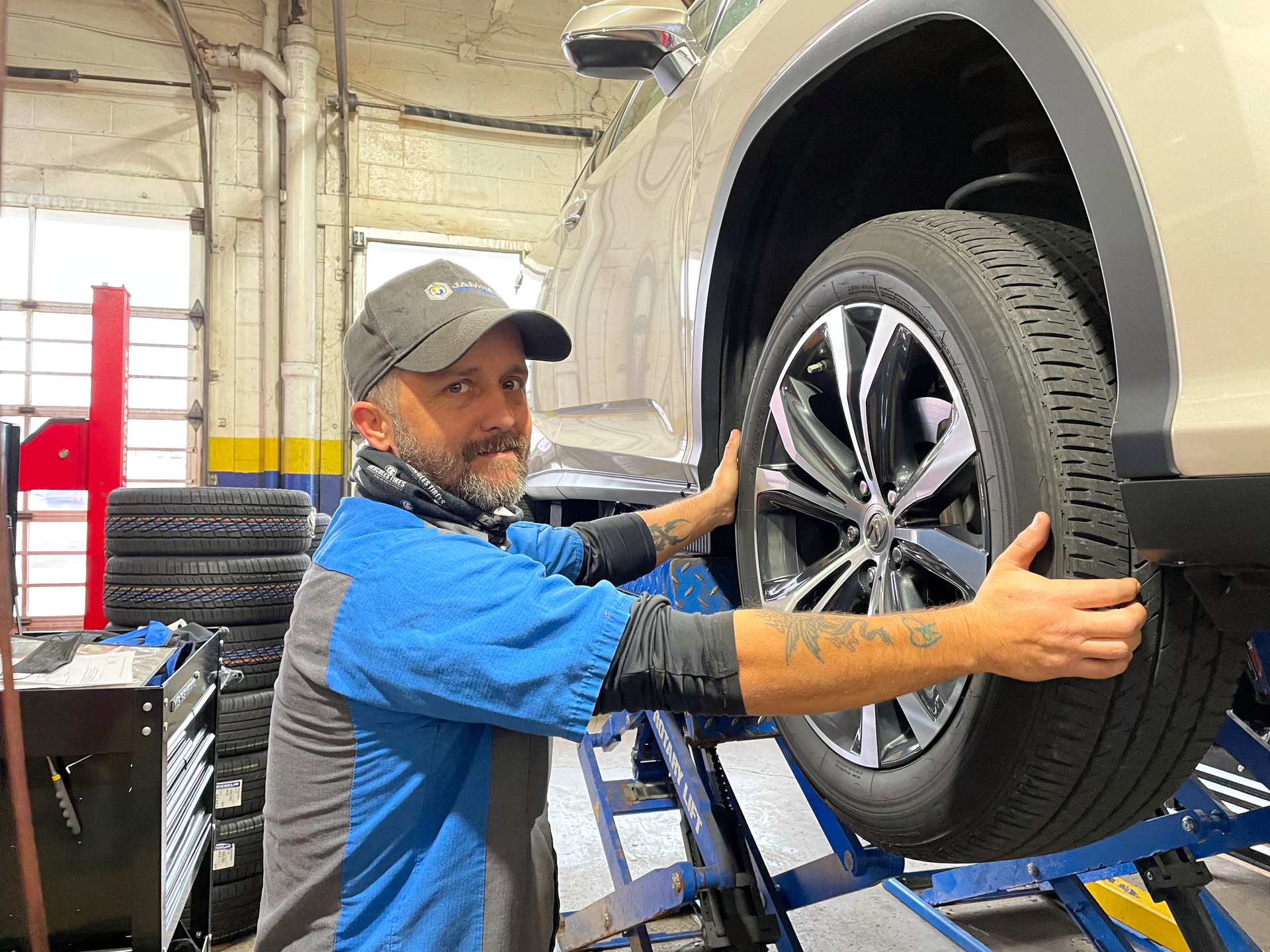 Technician installing a tire on a vehicle during a tire rotation at Jamie's Tire & Service in Dayton