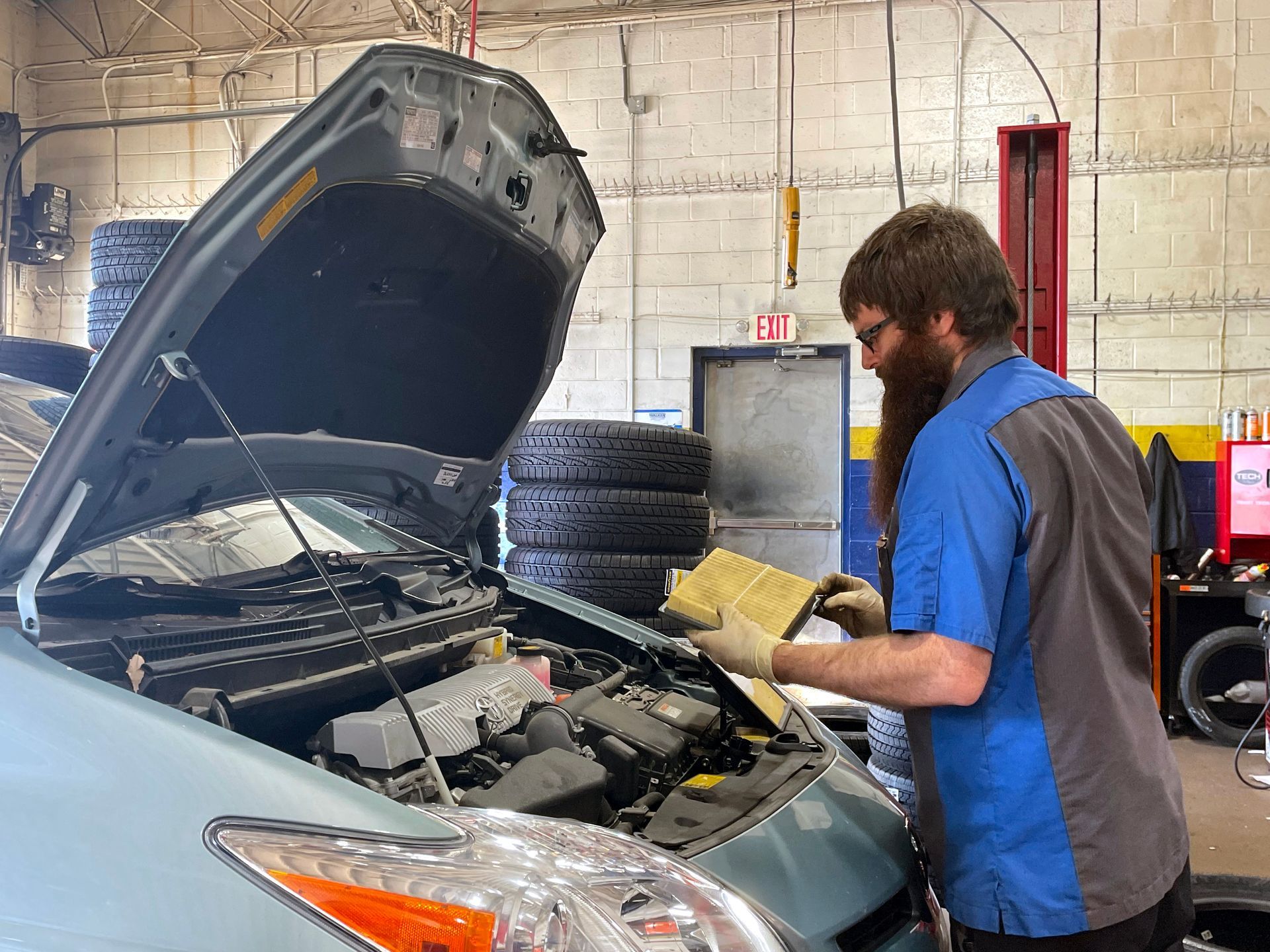 Technician checking the air filter on a Toyota
