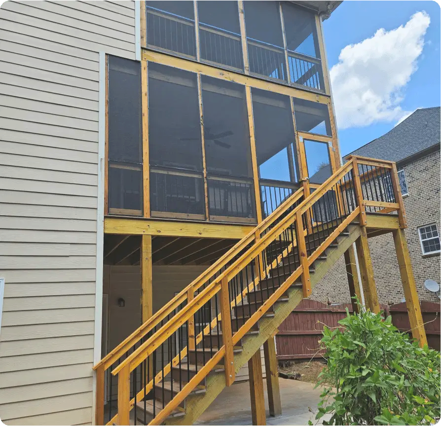 A screened in porch with stairs leading up to it.