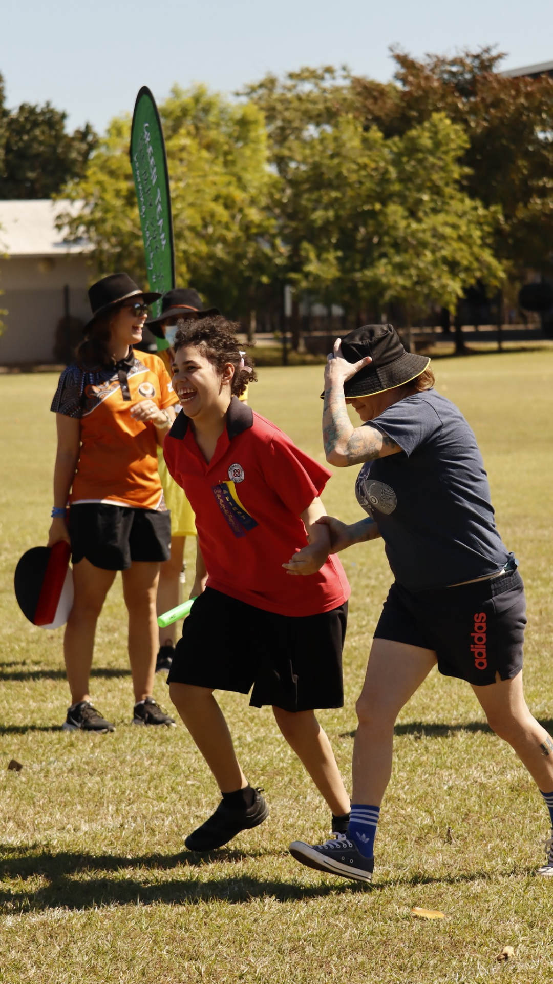 A group of people are playing frisbee in a field.