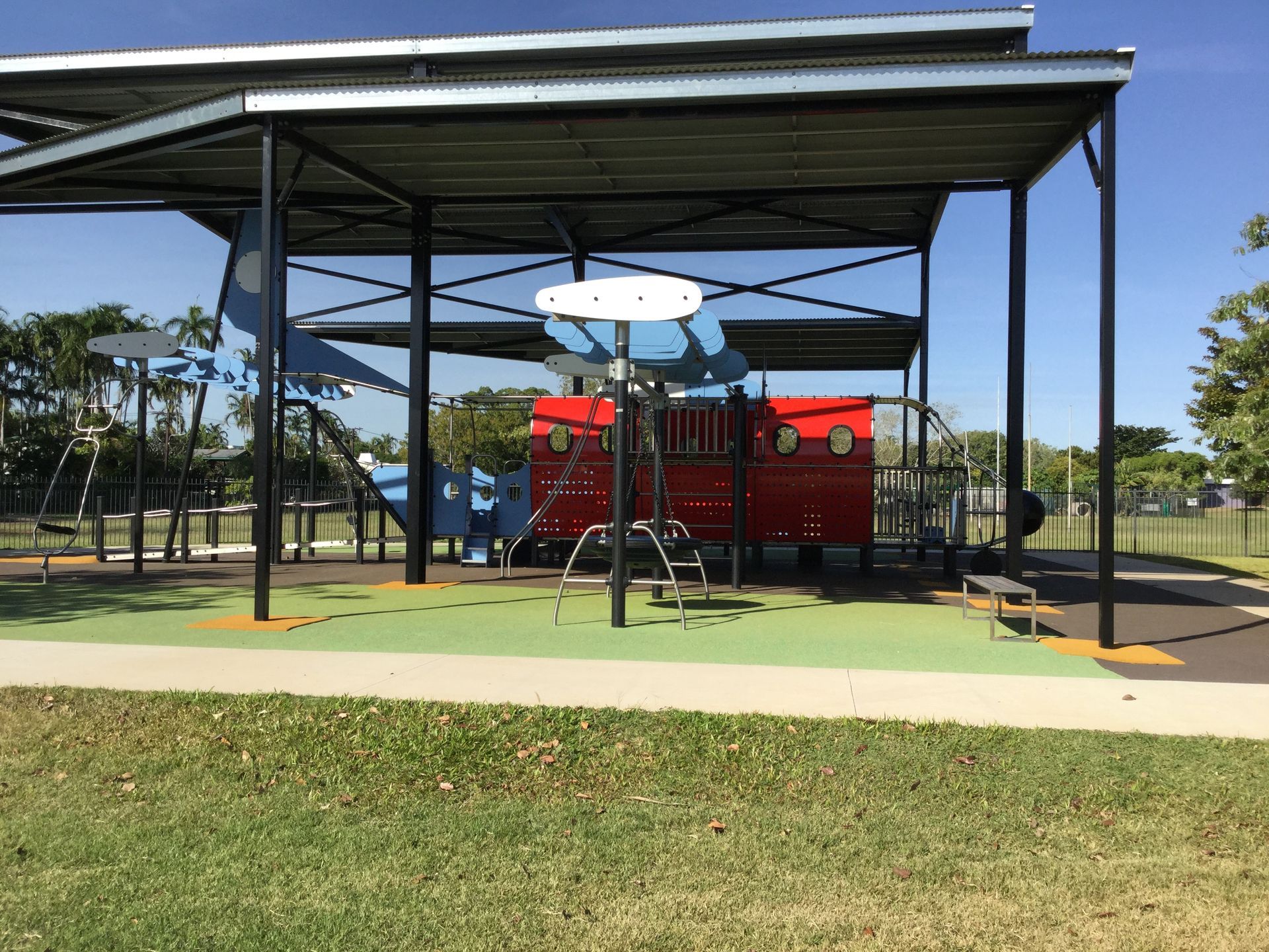 A playground with a helicopter in the middle of it