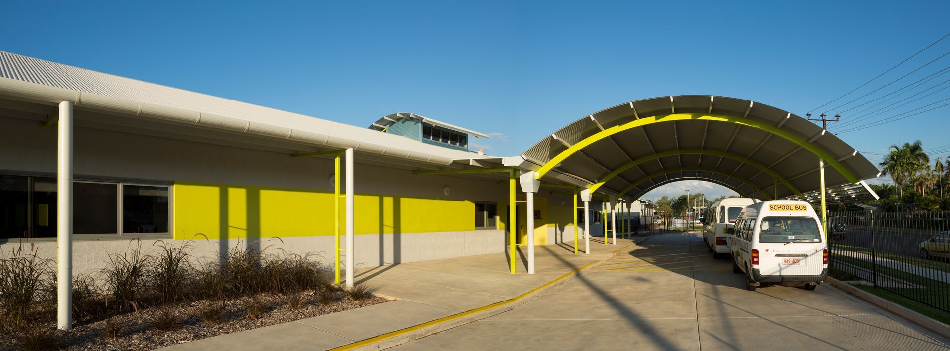 A yellow and white building with a canopy over it.