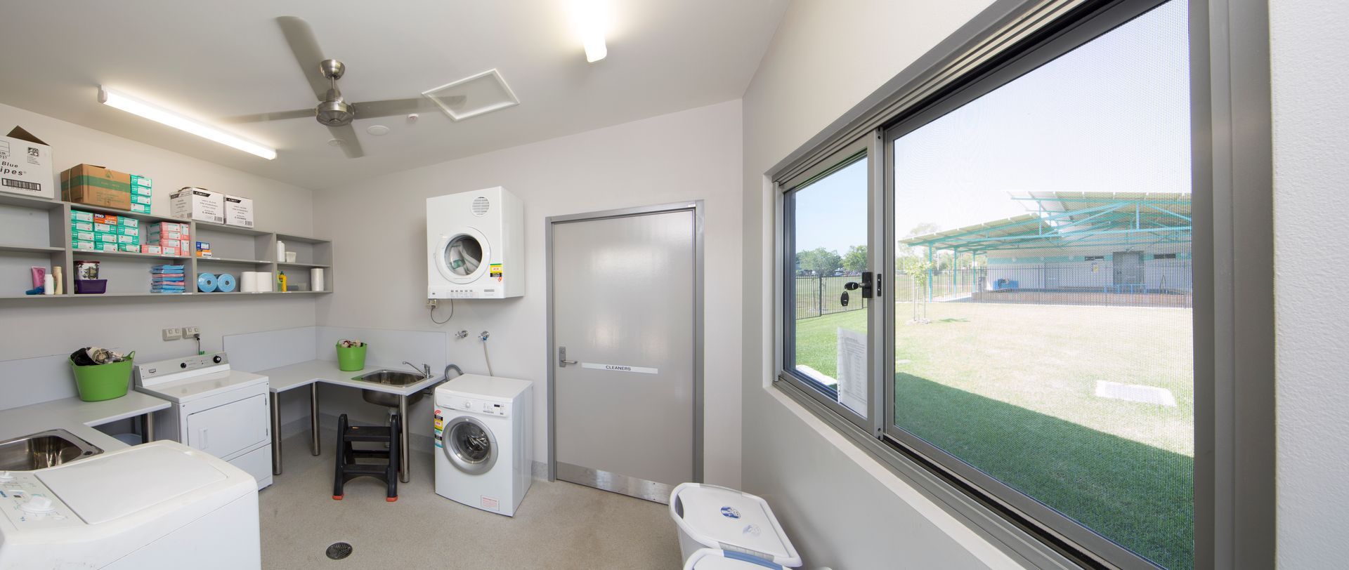 A laundry room with a washer and dryer and a window.