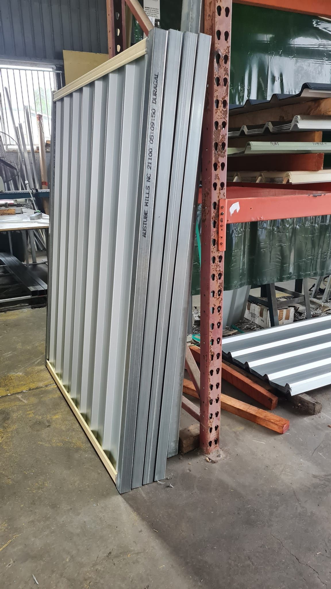 Stack of Corrugated Metal Sheets in a Warehouse — Metal Fencing Supplies In Gloucester, NSW
