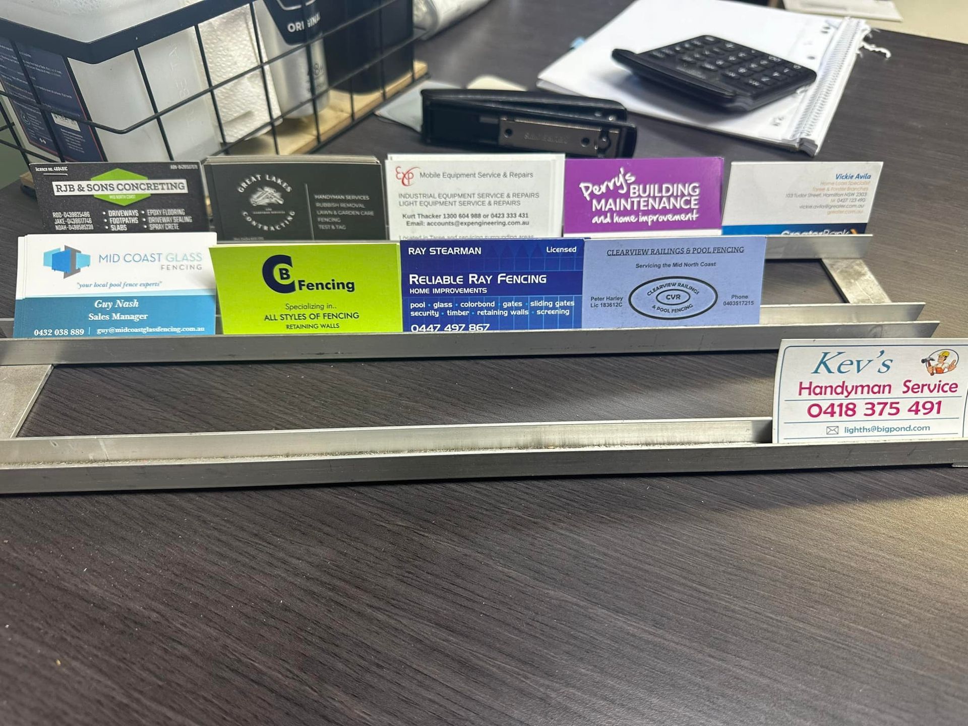 Business Cards in a Metal Display, With Office Supplies in the Background — Metal Fencing Supplies In Taree, NSW