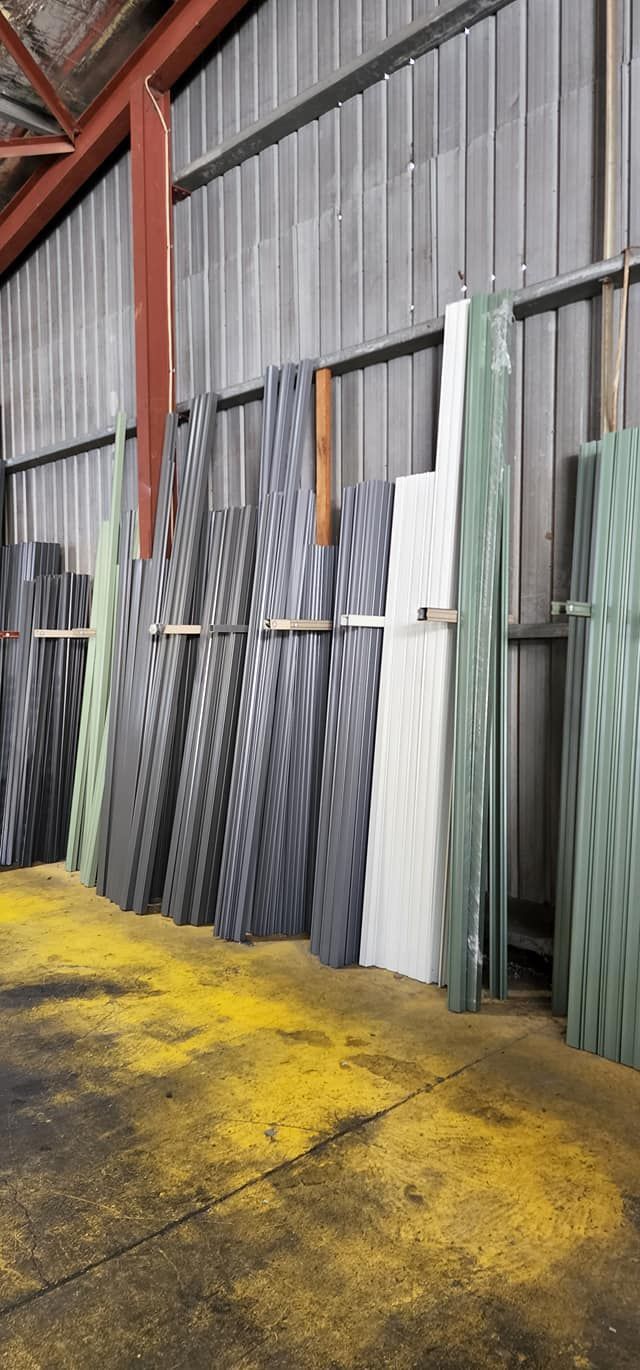 Glass Sheets Stored in a Warehouse. Yellow Debris Covers the Floor — Metal Fencing Supplies In Harrington, NSW