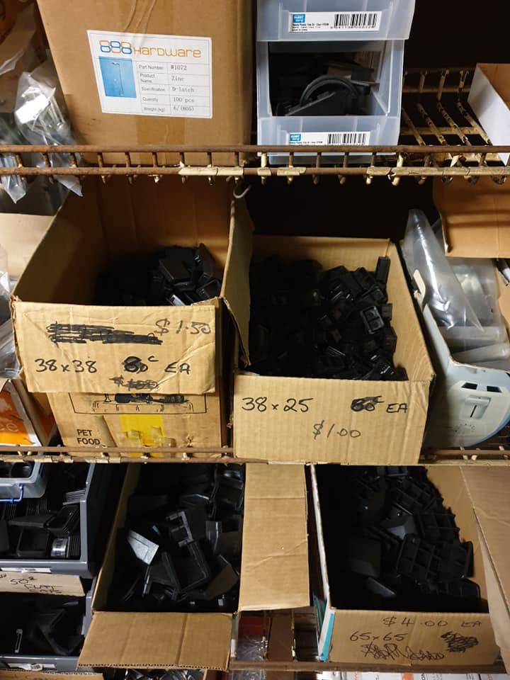 Boxes of Black Plastic Parts on Shelves in a Storage Area — Metal Fencing Supplies In Wingham, NSW