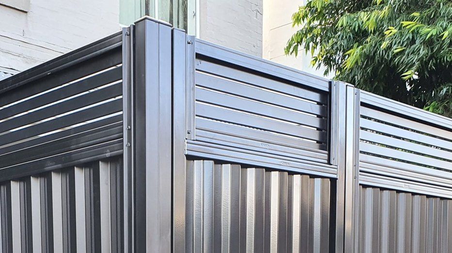 Black Metal Fence With Horizontal Slats and Vertical Corrugated Panels — Metal Fencing Supplies In Taree, NSW