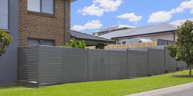 Residential Property With a Gray Horizontal Slatted Fence — Metal Fencing Supplies In Taree, NSW