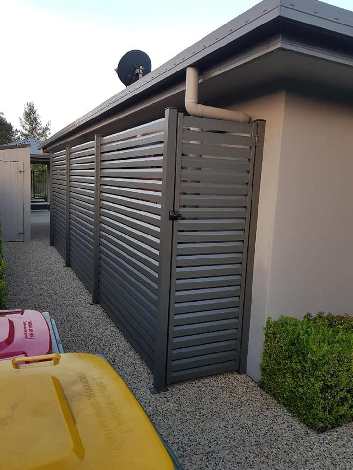 Gray Slat Fence Beside a House — Metal Fencing Supplies In Taree, NSW