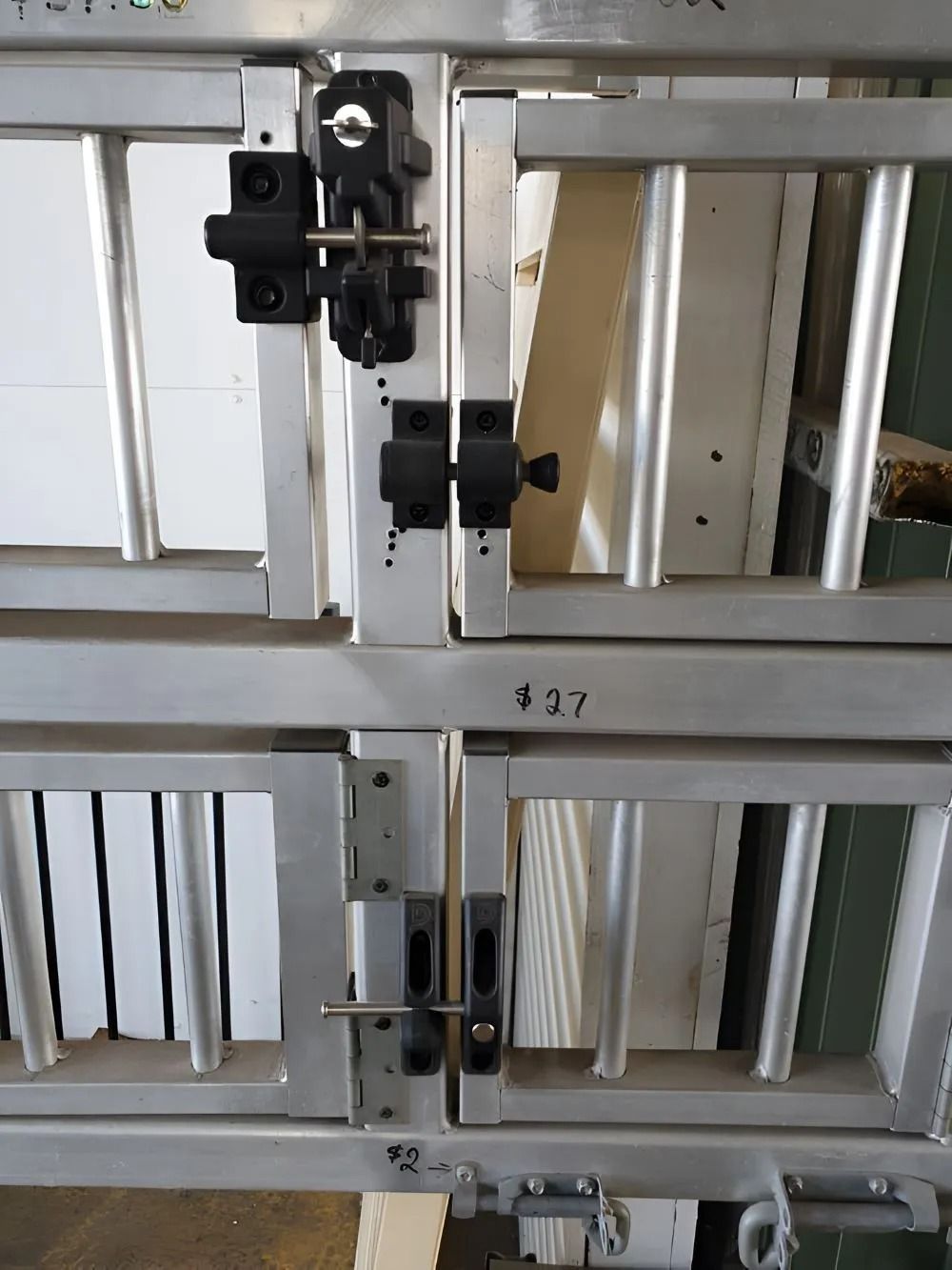 Metal Door With Several Latches, Set in a White and Silver Frame — Metal Fencing Supplies In Harrington, NSW