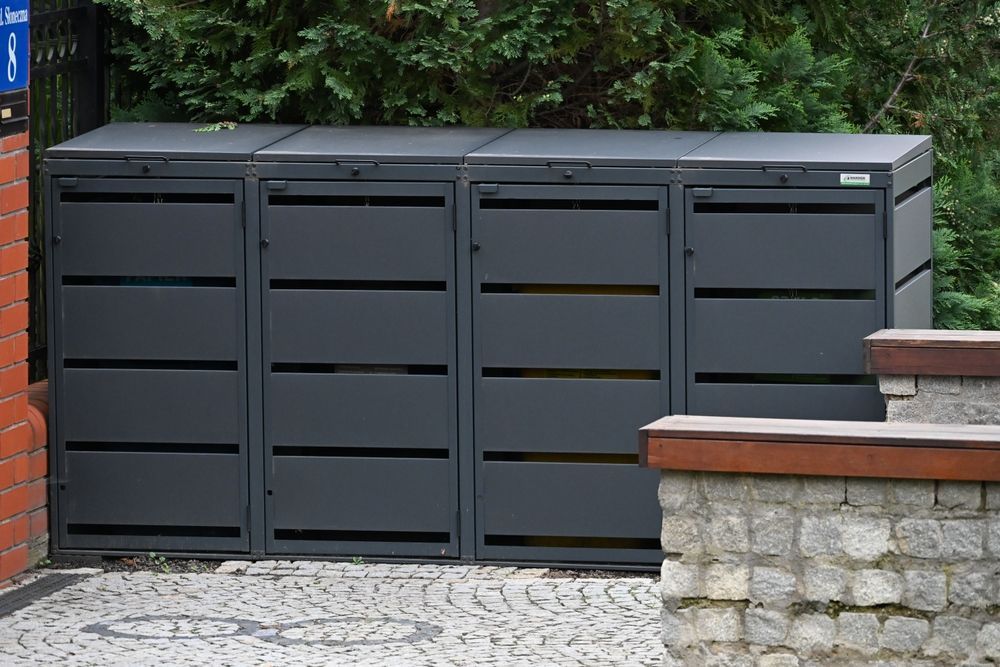 Four Gray Metal Trash Bins With Horizontal Slats, Outdoors — Metal Fencing Supplies In Harrington, NSW