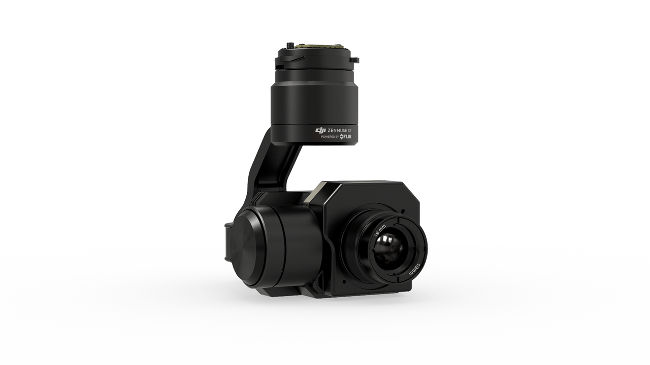 A black camera placed on a white surface highlights its sleek design.