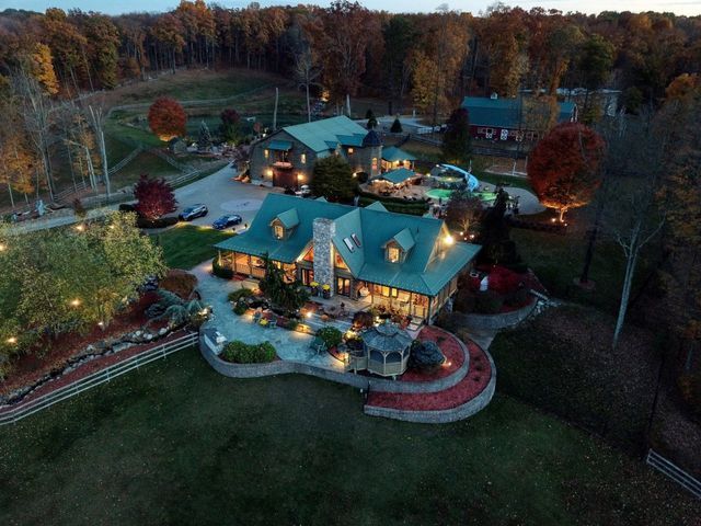 Aerial landscape photography of a large house in the middle of a forest.