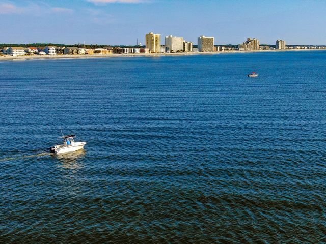 Hudson Valley Drones captures a stunning view of a boat floating on the vast ocean.