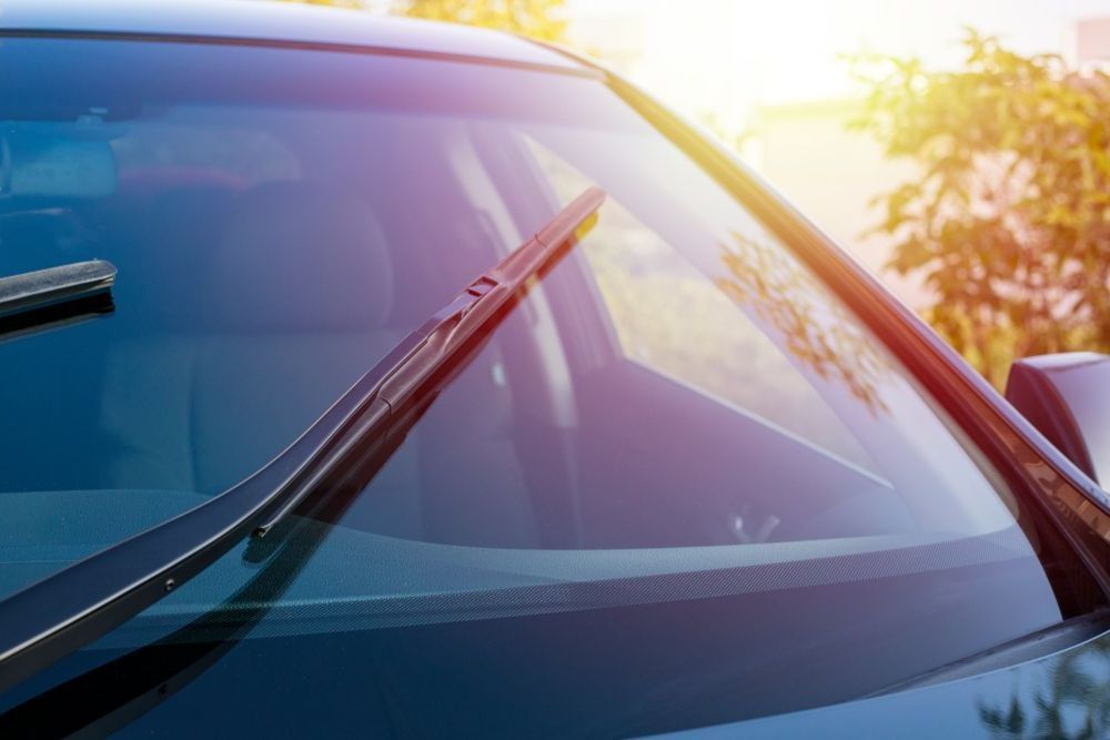 A Close Up of a Car Windshield With Wiper Blades on It — Bendigo Windscreens In Bendigo, VIC