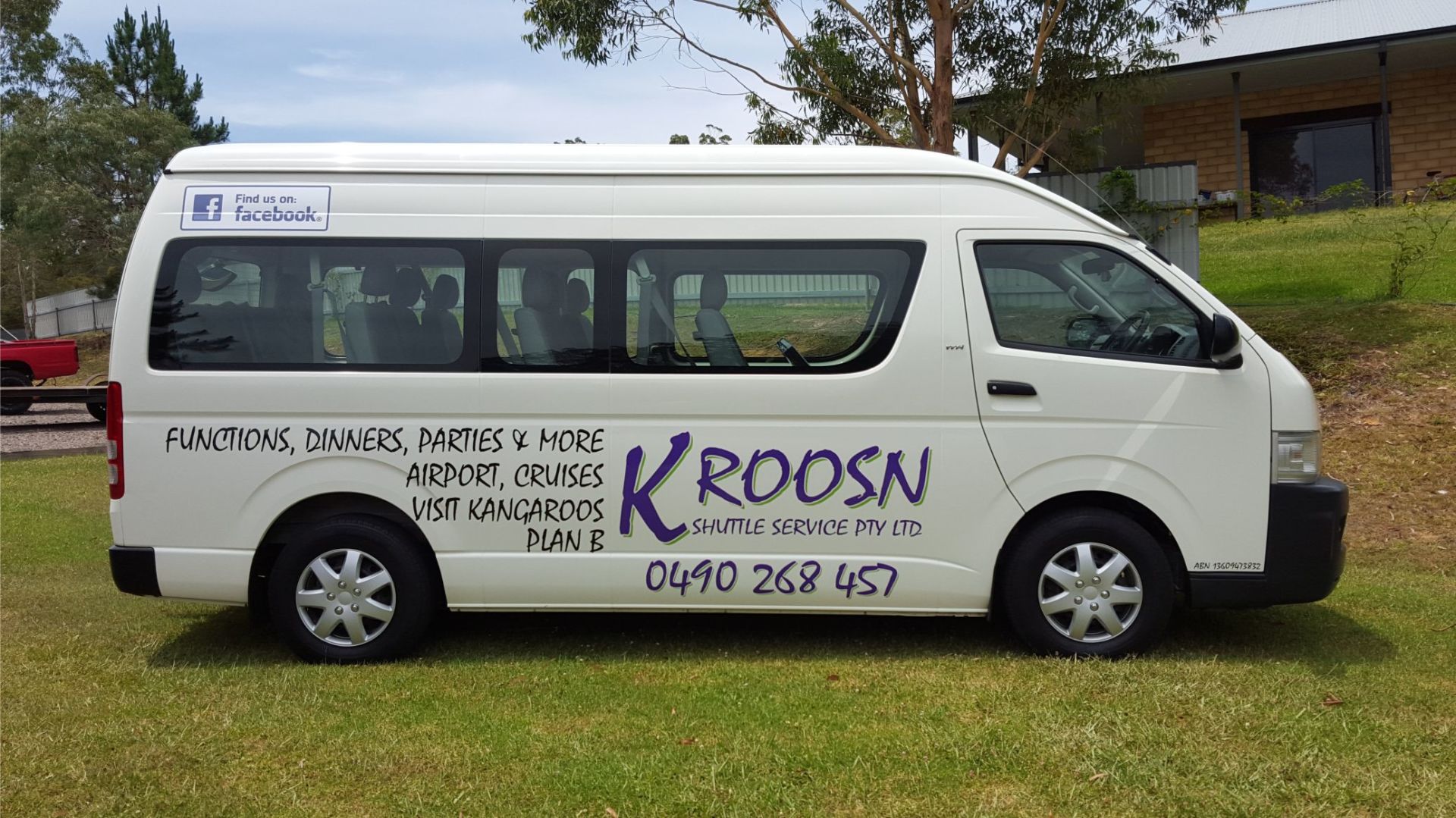 Side view of a mini bus with branding