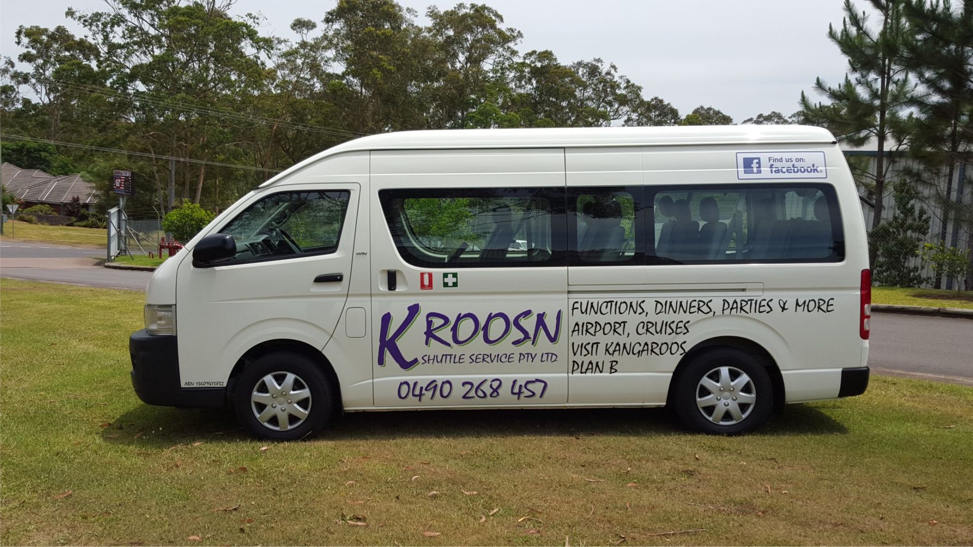 Side view of a mini bus with branding