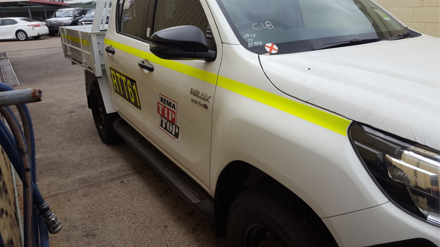 Side view of a pickup truck with branding logos