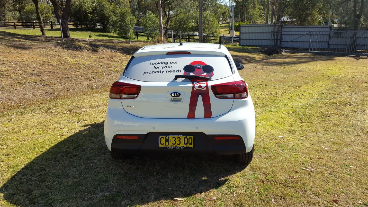 Rear view of an automobile with vehicle branding