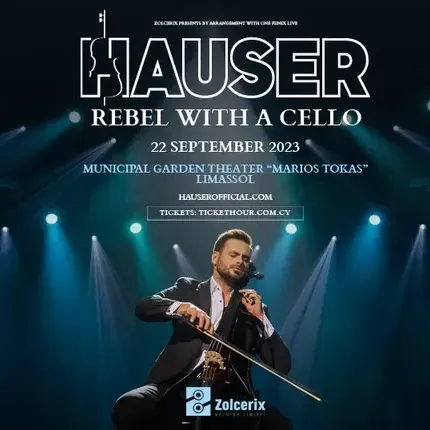 A man in a suit is playing a violin on a stage.