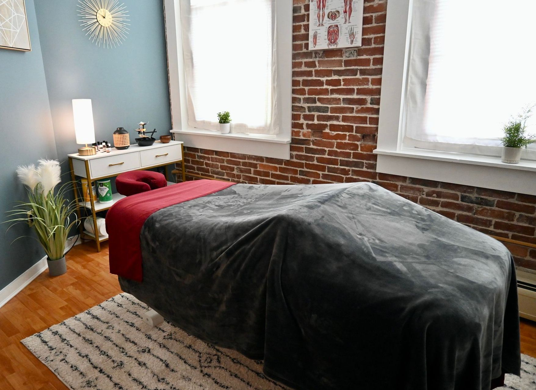 a room with a table , chair , shelves , and a bed
