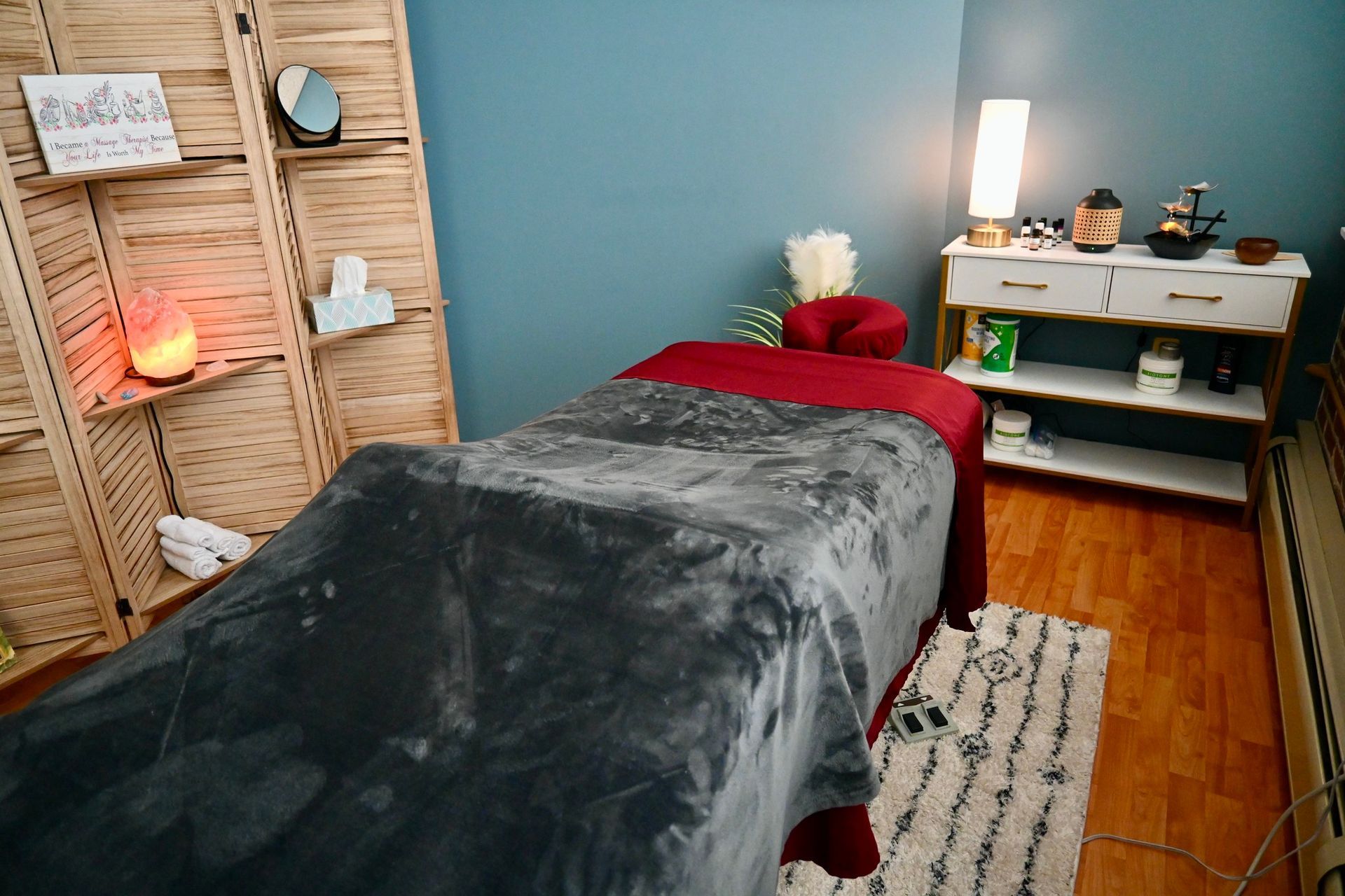 There is a massage table in the middle of the room.