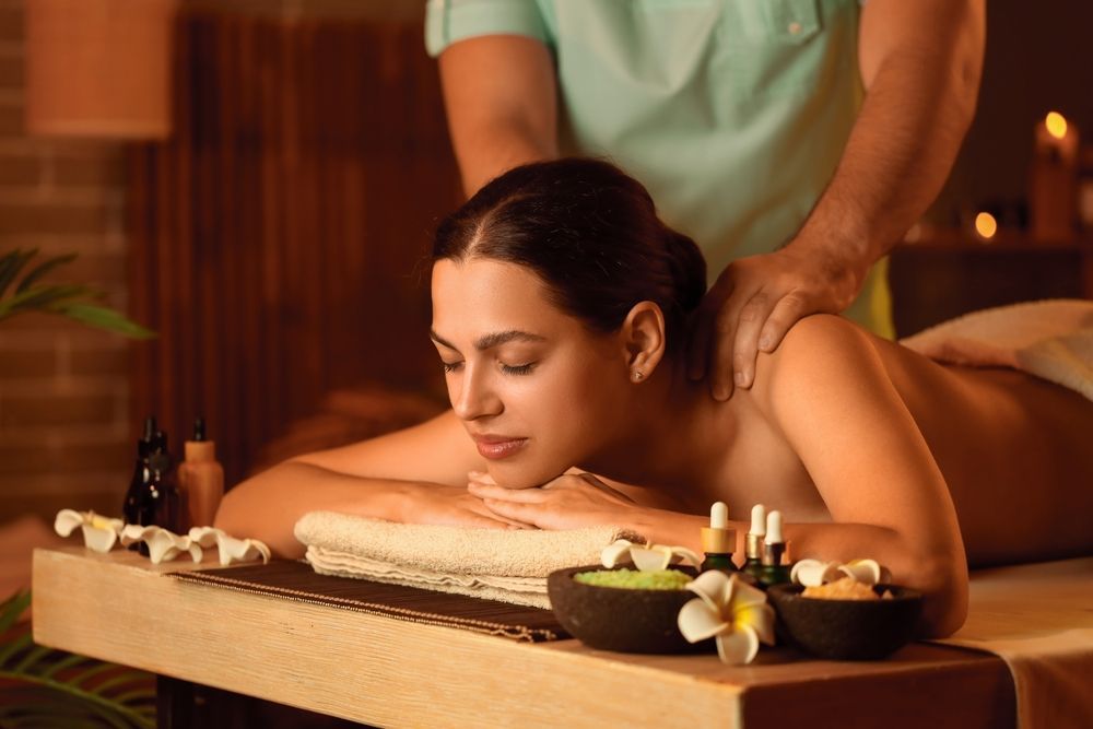 a pregnant woman is getting a massage at a spa