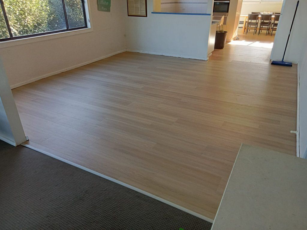 A New Light-wood Laminate Floor is Installed in a Room — BLB Flooring Solutions in Raymond Terrace, NSW