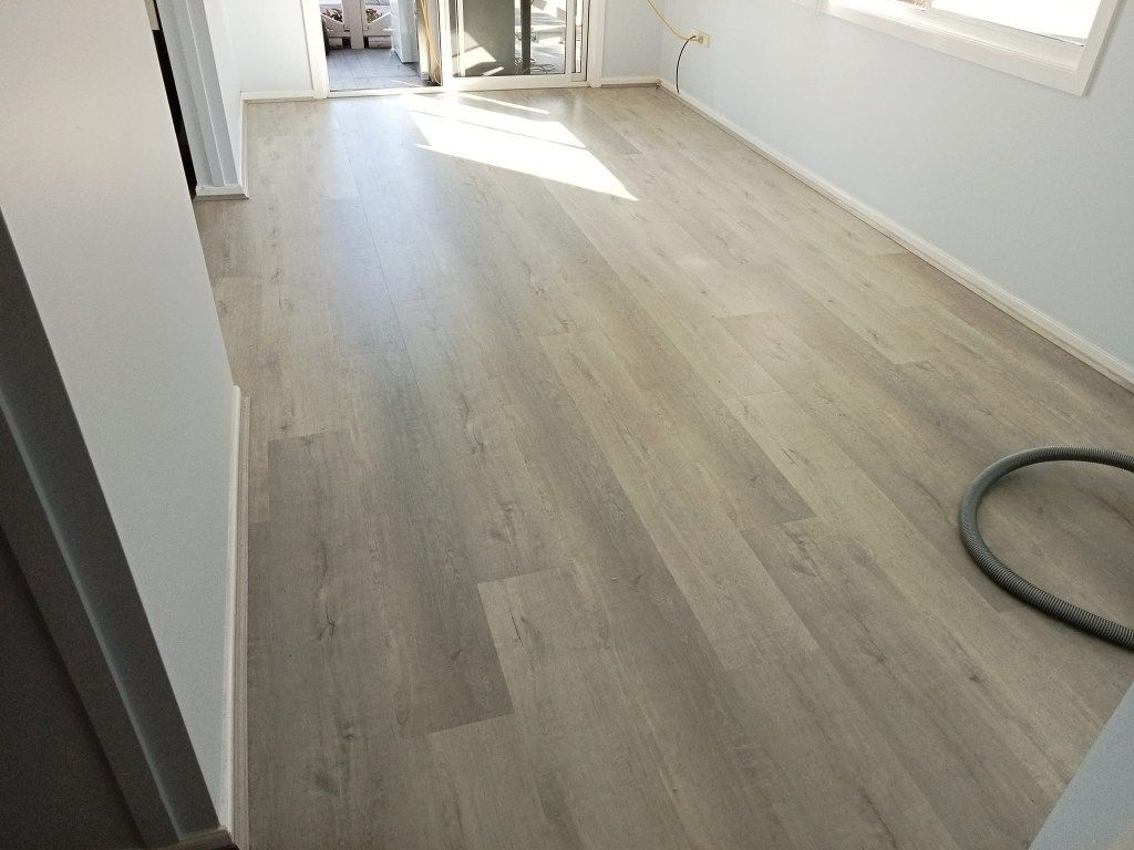 A Room With Light Gray Wood-look Flooring — BLB Flooring Solutions in Raymond Terrace, NSW